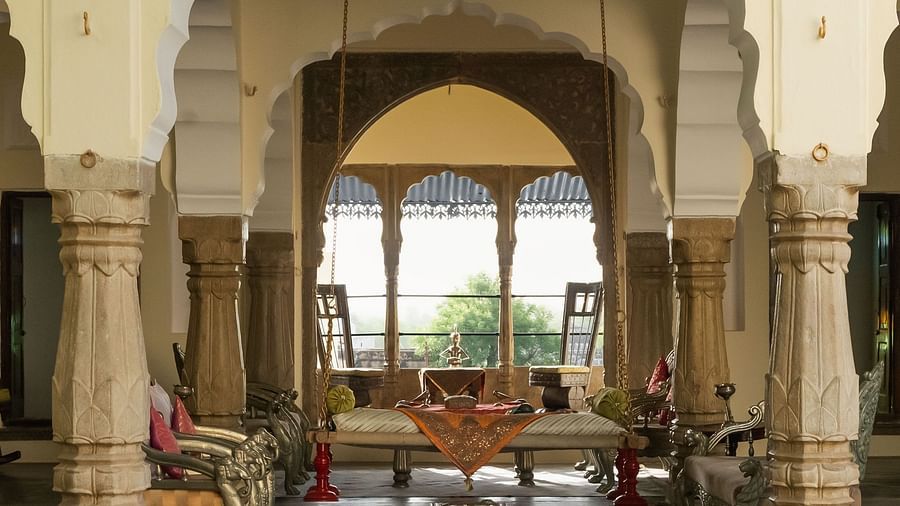 An ornate arched doorway frames a glimpse into a serene interior space at Fort Barli, hinting at the fort's architectural elegance.