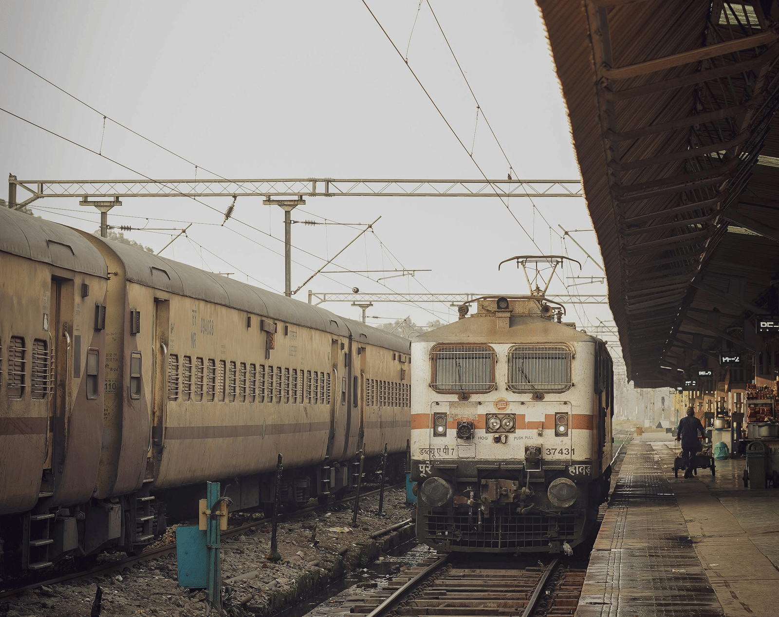 An Indian railway locomotive stationed on a platform at a railway station.