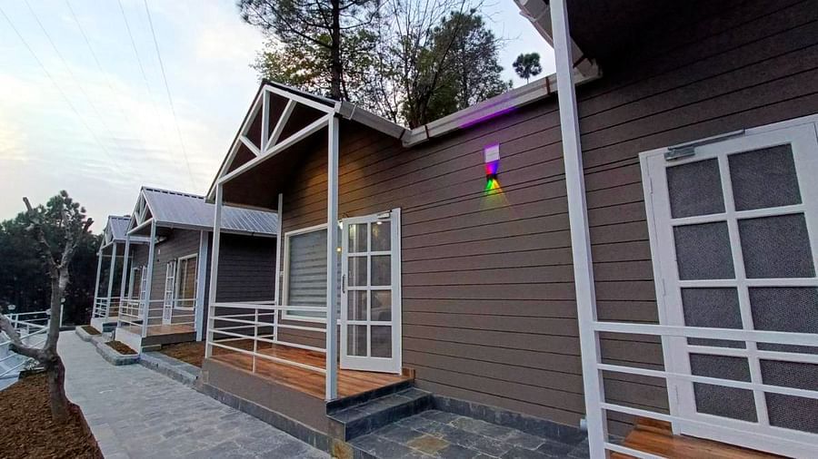 A side view of the exterior of DLS Nature Trinket Resort with a brown building and a clear sky in the backdrop.