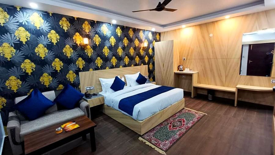 A Deluxe Room at DLS Nature Trinket Resort with a king size bed and a sofa.