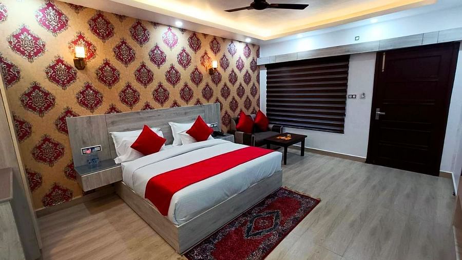 A Premium Room at DLS Nature Trinket Resort  with a king size bed and side tables.