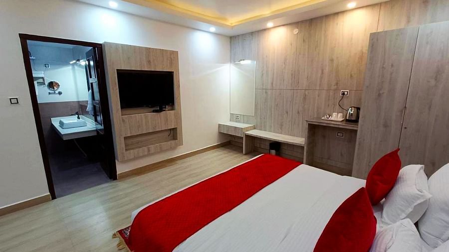 A Premium Room at DLS Nature Trinket Resort with a king size bed and a side table.