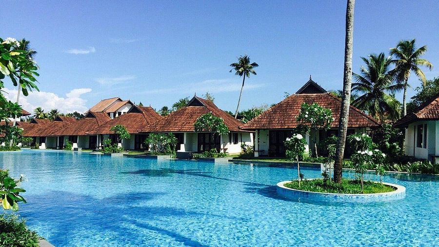 Pool with resort lodgings in the background - Rhythm Kumarakom