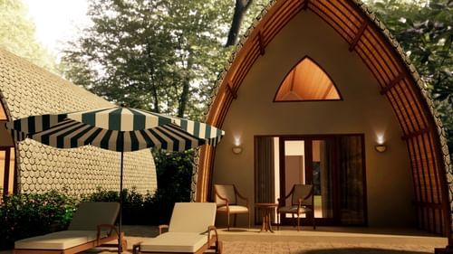 Bamboo Villa in view with a lounger in front of it - Ananta Spa and Resort, Ajabgarh