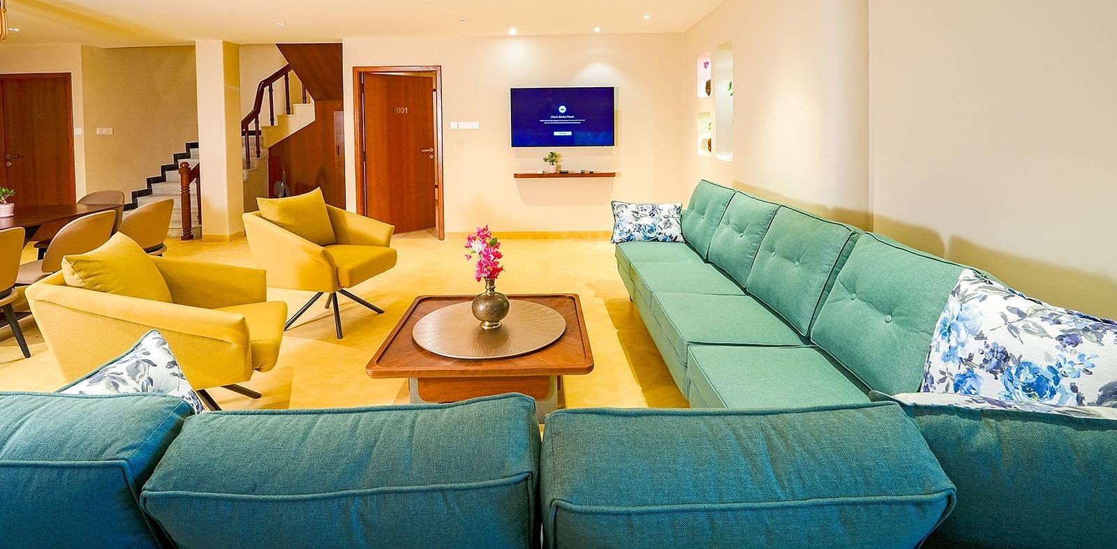 Vasundhara Villa vibrant living room with plush seating, flat-screen TV, and modern interiors at Ramoji Film City.