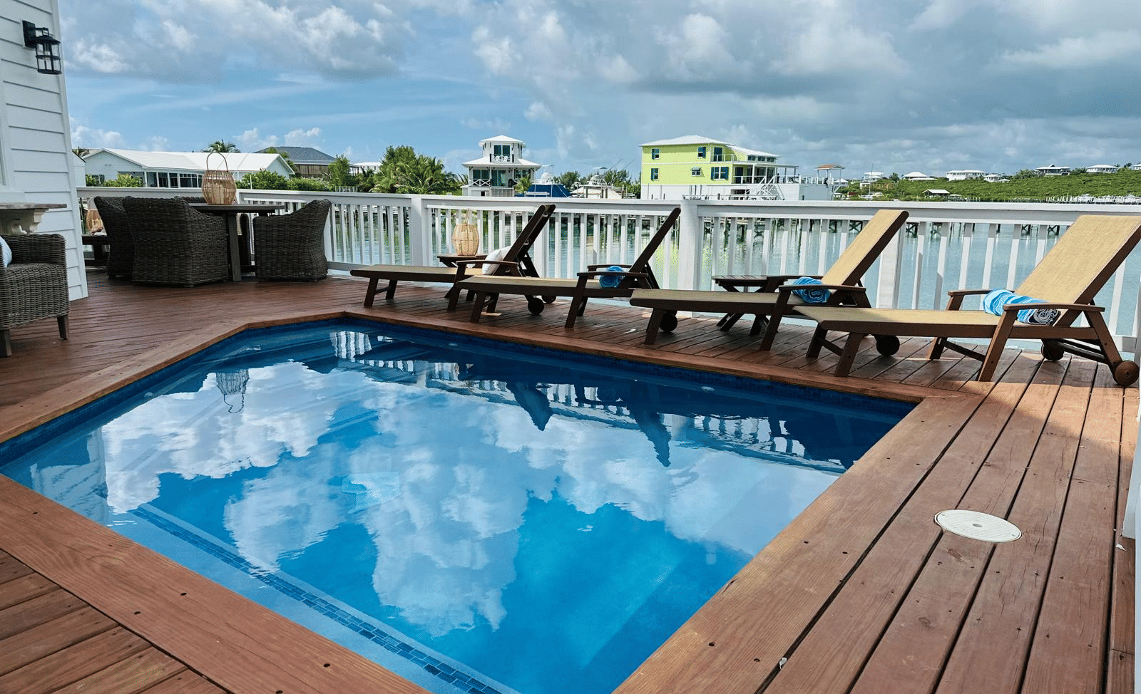 A view of a deck with small pool and sunbeds at Elbow Room Villa 7 in  Abaco inn