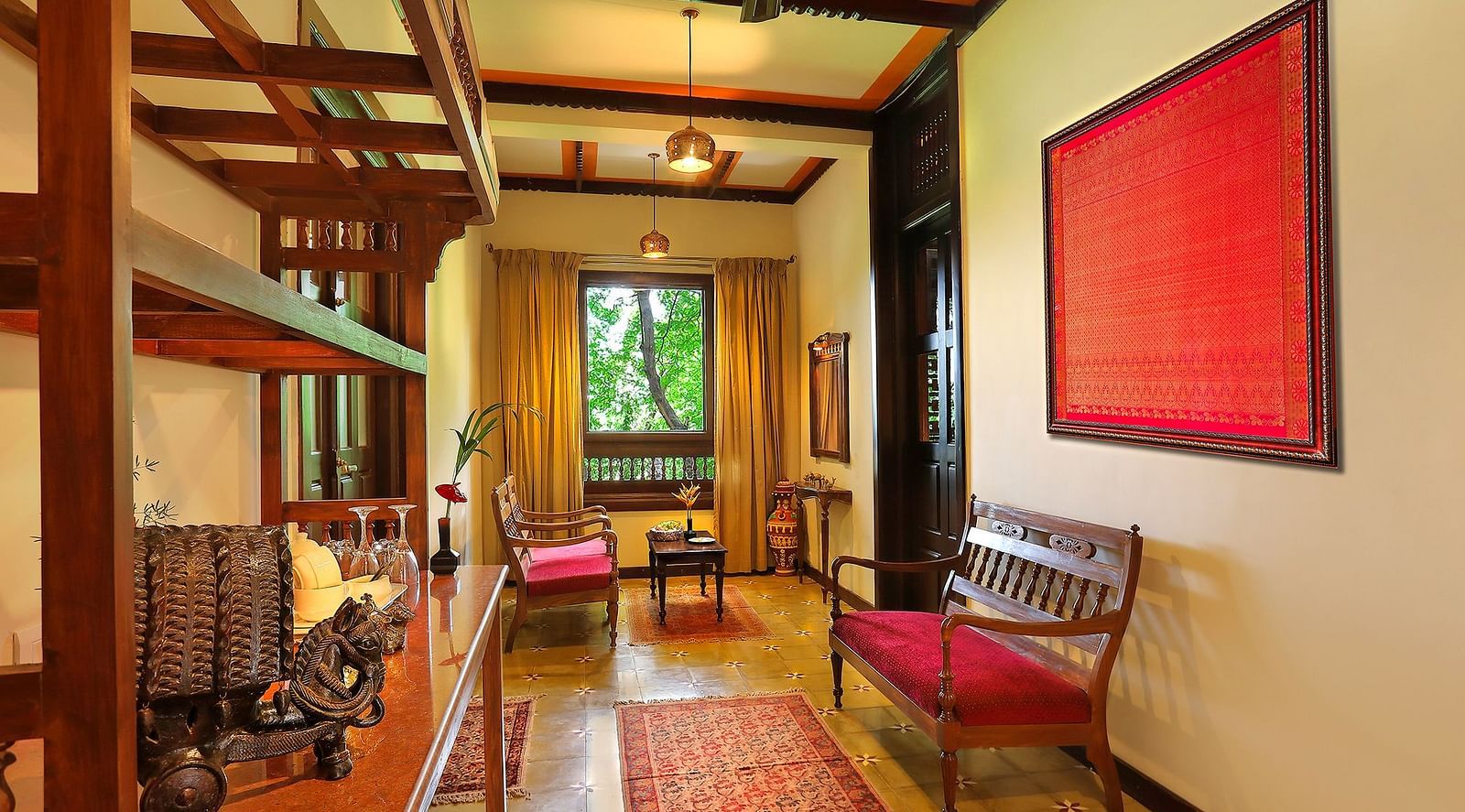 image of the living room featuring a small window at the end of the area at malnad palace suite at hoysala village resort in hassan