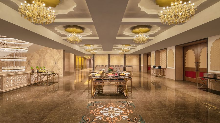A banquet area with a long table, elegant decor, and chandeliers – Kaldan Samudra Palace, a stunning Luxury Marriage Hall ECR