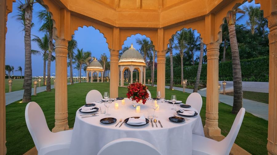 A gazebo with a dining setup, cosy lighting and views of the sea - Kaldan Samudhra Palace