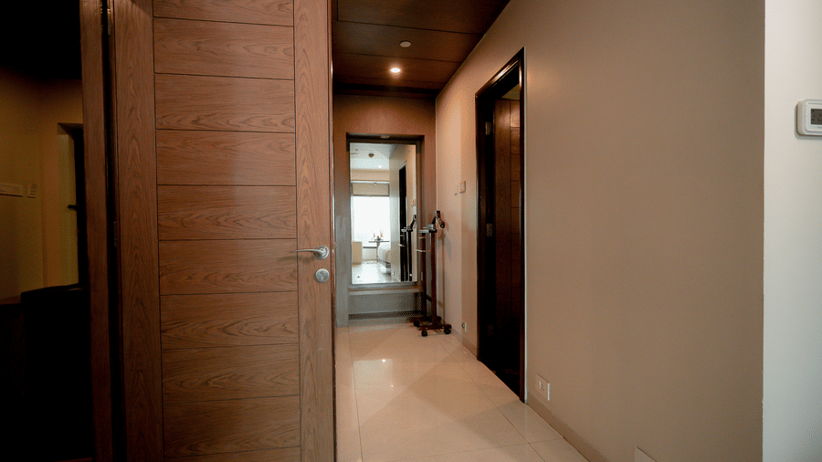 Hotel corridor leading to rooms with polished flooring and warm lighting - Narayani Heights Hotel & Resorts