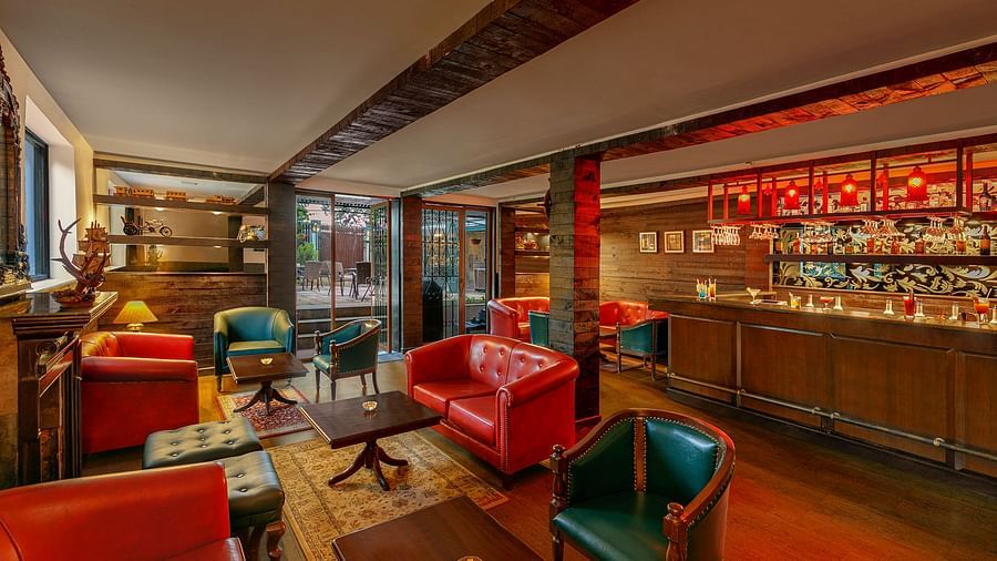  A image of a resturant with tred lighting with table and chair setting well decorated with bar also present at Shervani Hiltop 