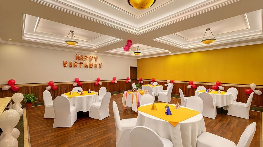 A image of a banquet with chair and table well lit and well furnished 