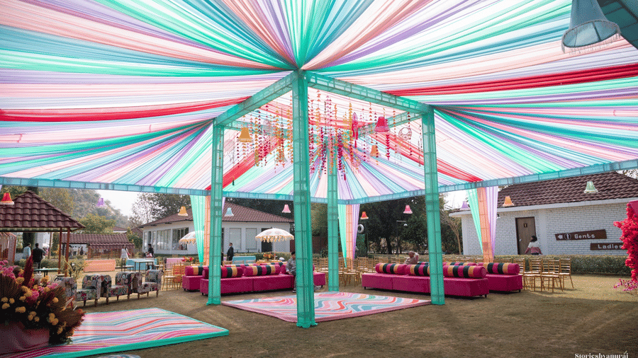 Event space arranged with chairs, carpets, and decor at Valley by Grassfield, a wedding resort in Jaipur.