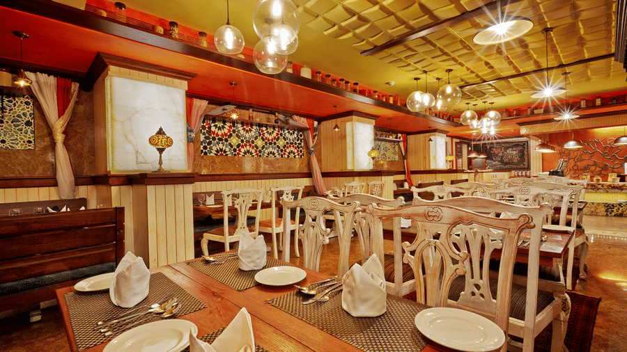 Dining tables with chairs at The Spice, a popular buffet restaurant in Chennai, located at Hablis Hotel.
