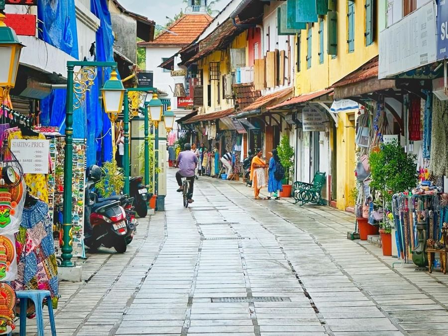 A colourful street scene in a traditional market area with narrow pedestrian lanes and vibrant buildings.