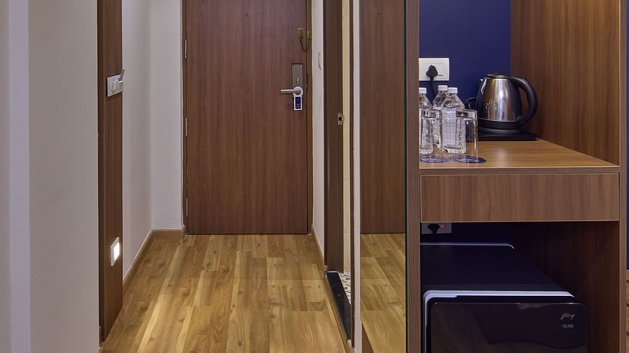 An entryway to a room with a wardrobe and tea station in the front - Grand Continent, Brookefield