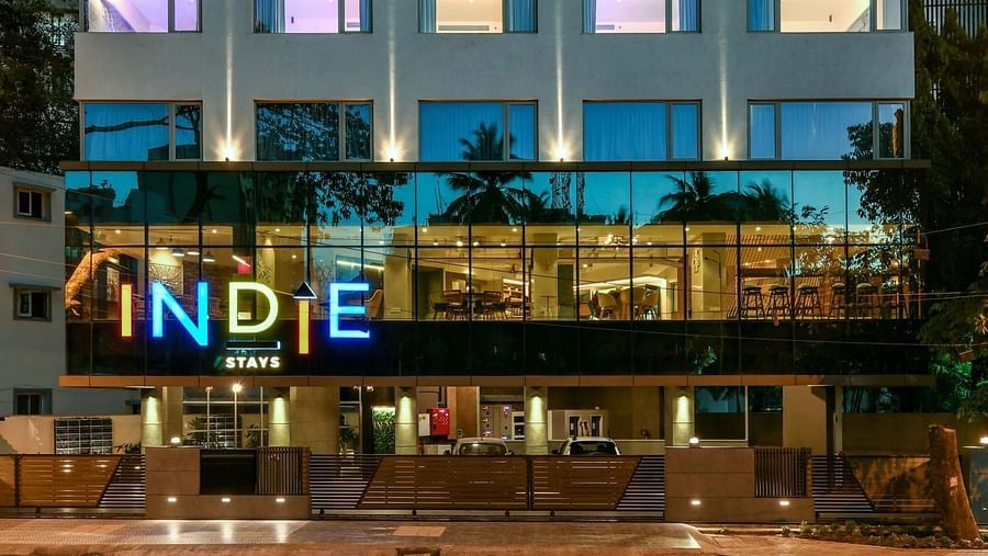 A close-up facade view of Indie Stays, BKC Kalina, illuminated against the night sky.