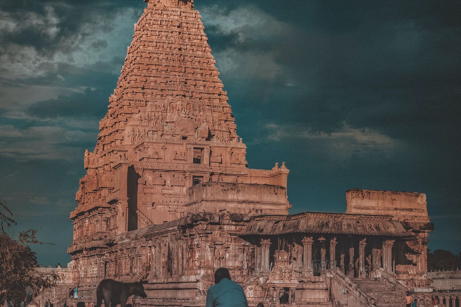 A long shot image of a hindu temple with intricate architecture seen from a distance