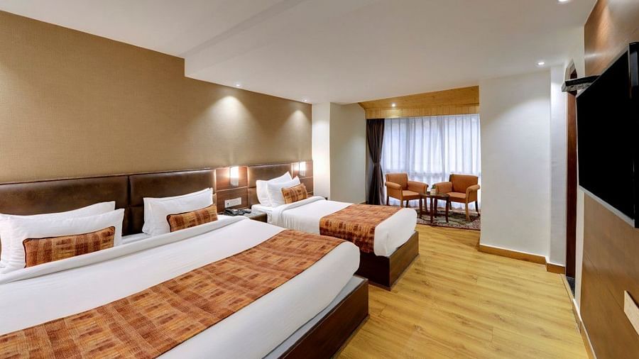 A large double bed and a single bed i n the Premium Triple Room at Hotel Sumitel Vista T.V Tower 