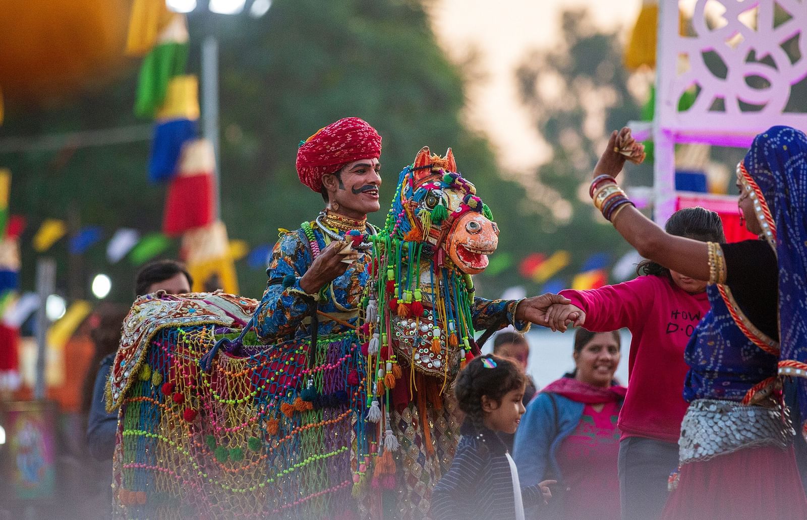 Man dancing on horse wearing colourful clothers in Mewar