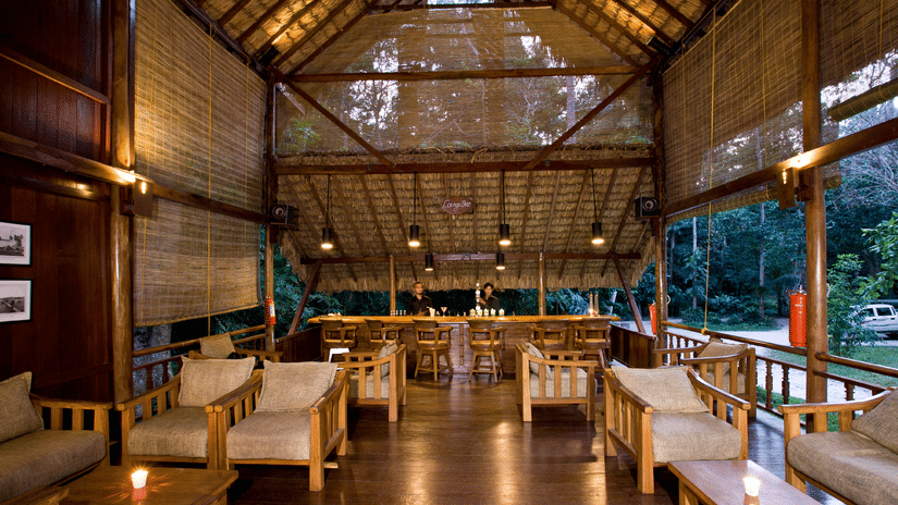 Tables arranged at Dugong Dugon Bar, our restaurant in Havelock, featuring 2 bartenders facing the 2 rows of chairs and tables