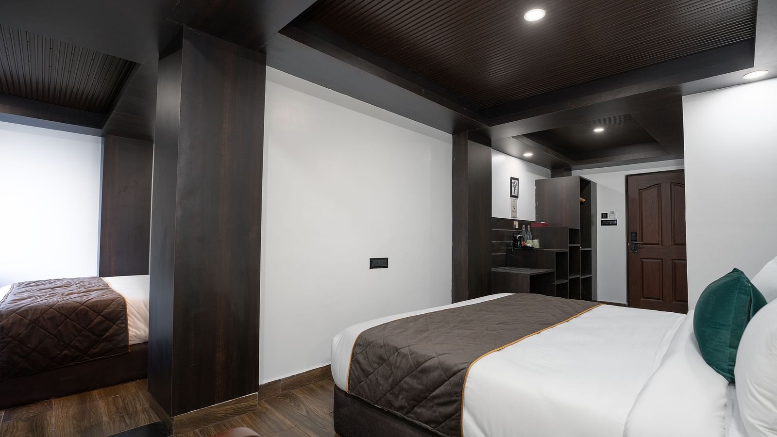Image of a bed in a room that is well furnished with wardrobe. 