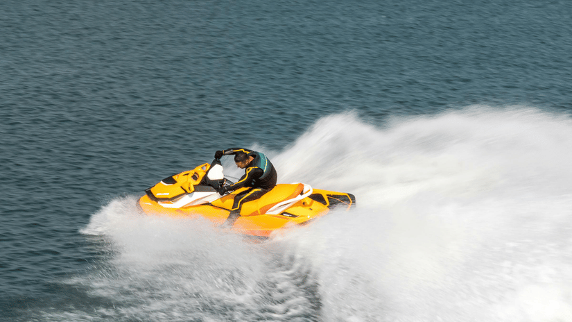 A person riding a jet ski on a clear, blue day