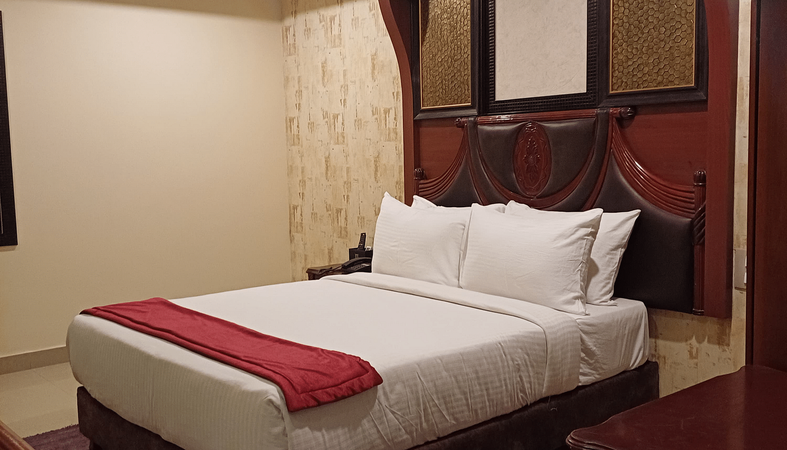 A room with king size bed