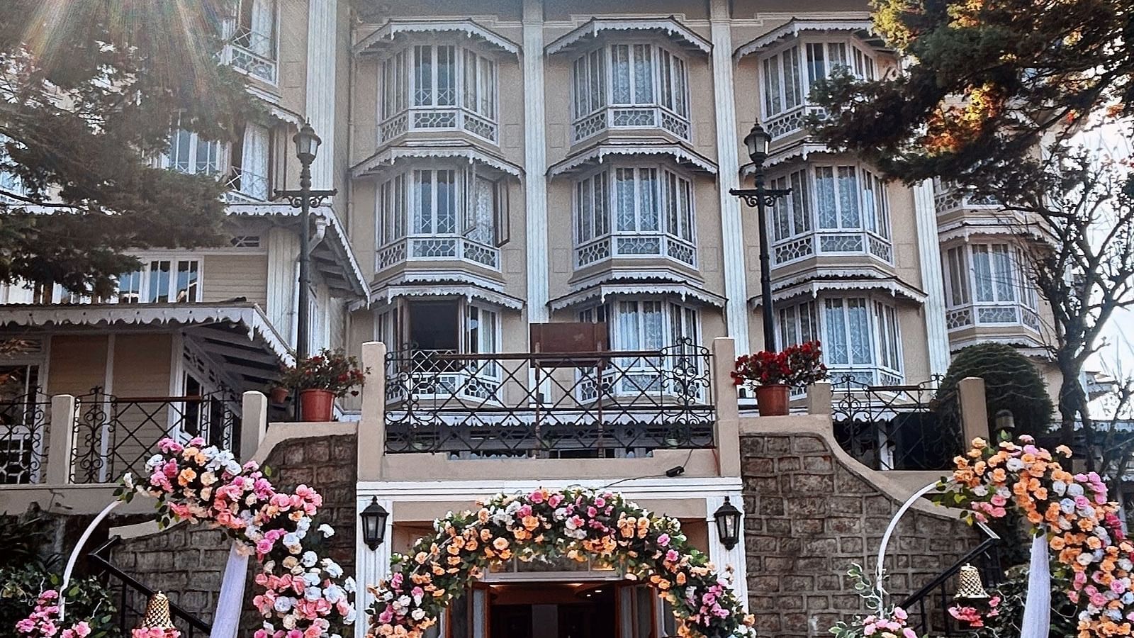 Wedding celebrations at Cedar Inn, Darjeeling, highlighting outdoor seating and traditional decor in front of the hotel façade.