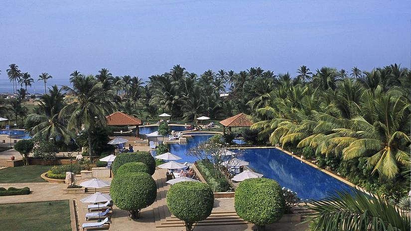 An aerial view of the pool, lawns and thick vegetation at Kenilworth Resort and Spa which is considered as one of the best resorts in Goa with private beach