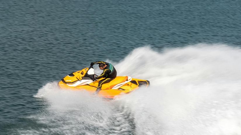 A person riding a jet ski on a clear, blue day