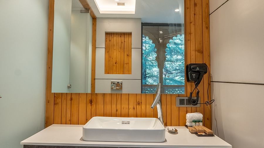 an image of a suite washroom with towels and a mirror at Mastiff Select Mandavya Dharamkot, McLeodganj