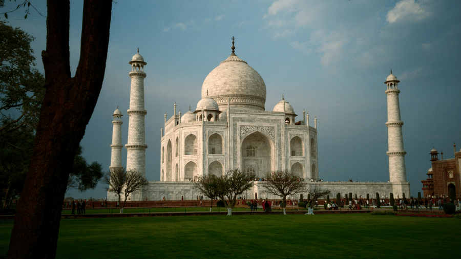 An image of Taj Mahal with a lawn in the front
