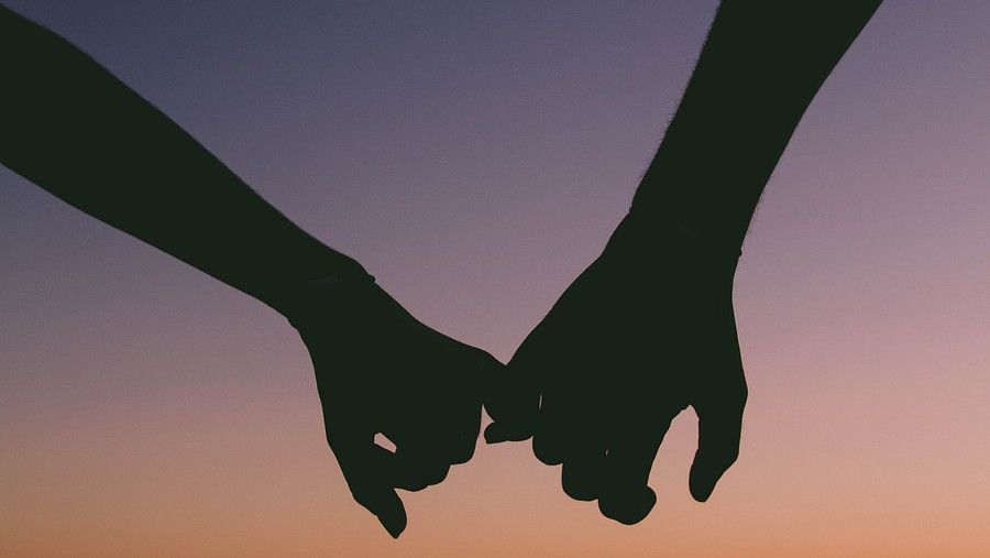 Couple holding hands during the sunset in Goa near the beach