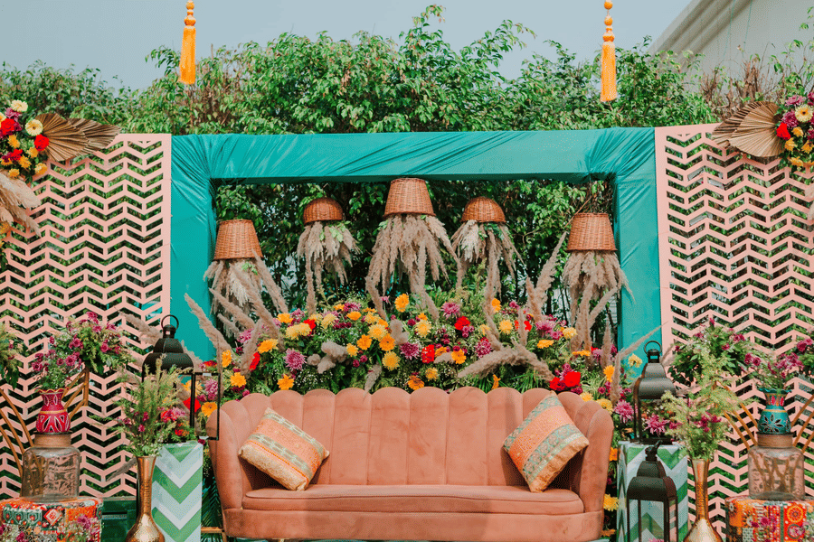 Decorated wedding stage at Marasa Sarovar Premiere, Bodhgaya featuring patterned flooring, floral backdrop, overhead decor, and central seating
