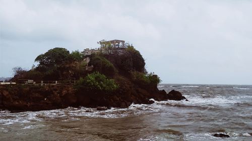 rock formation surrounded by the ocean