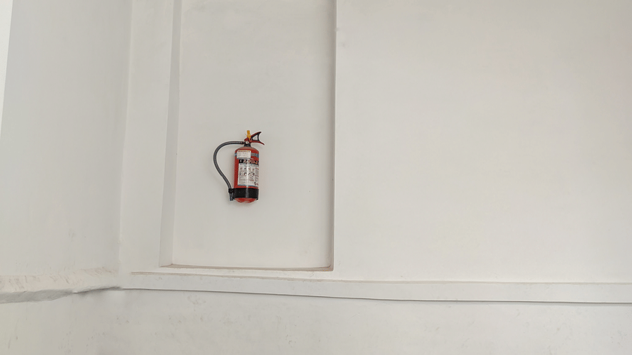 A fire extinguisher mounted on the wall - Hotel Goverdhan, Agra