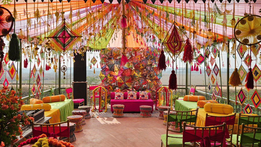 Bright and colourful mehendi or haldi ceremony décor with festive seating arrangement.