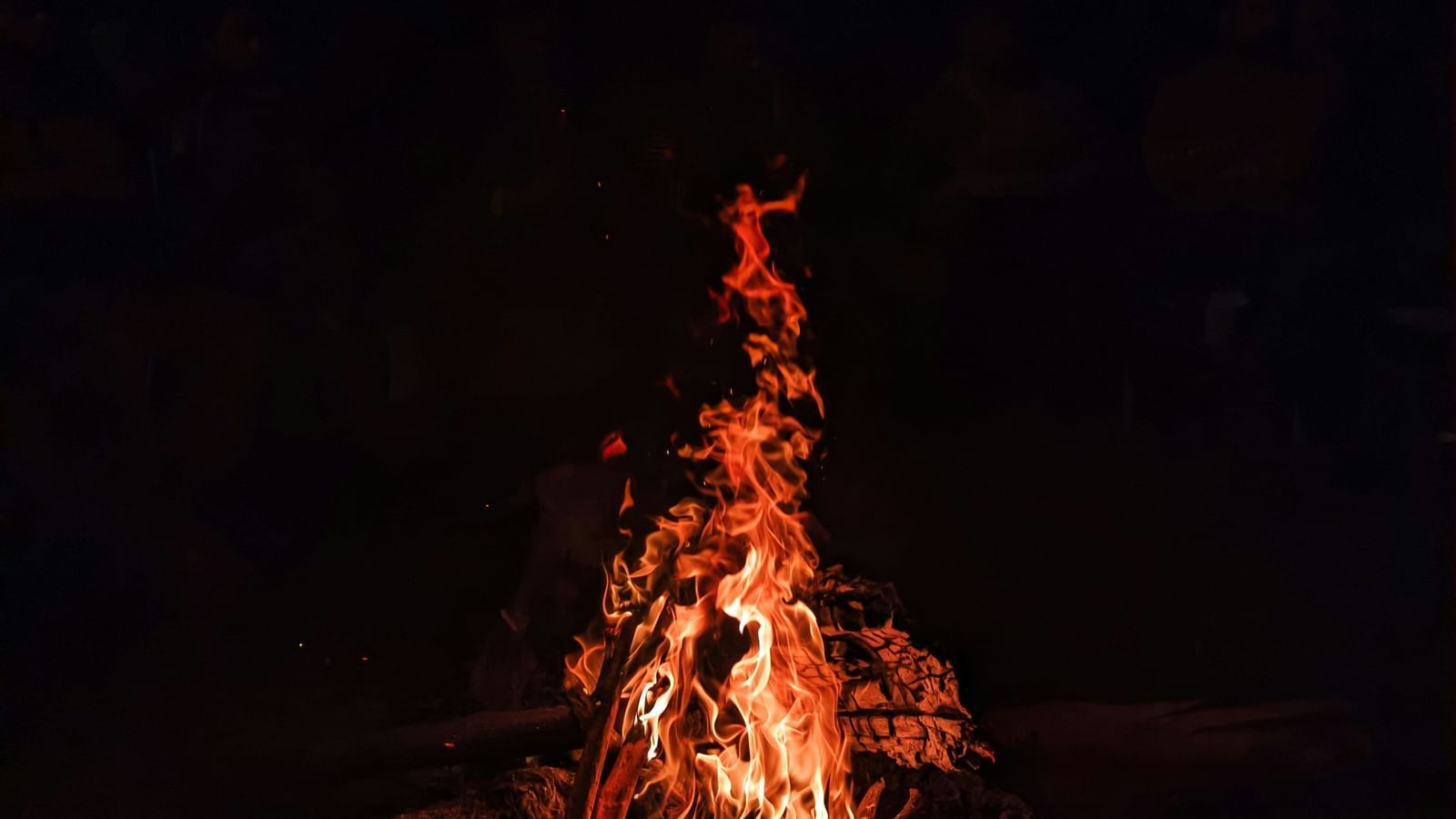 A blazing bonfire surrounded by darkness.