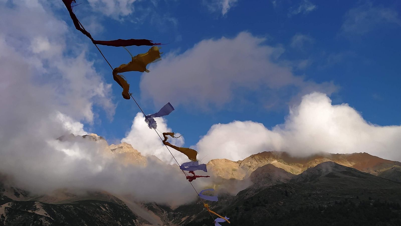 Image of prayer flages waving in the wind at Niti Valley | Faraway Cottages, Auli