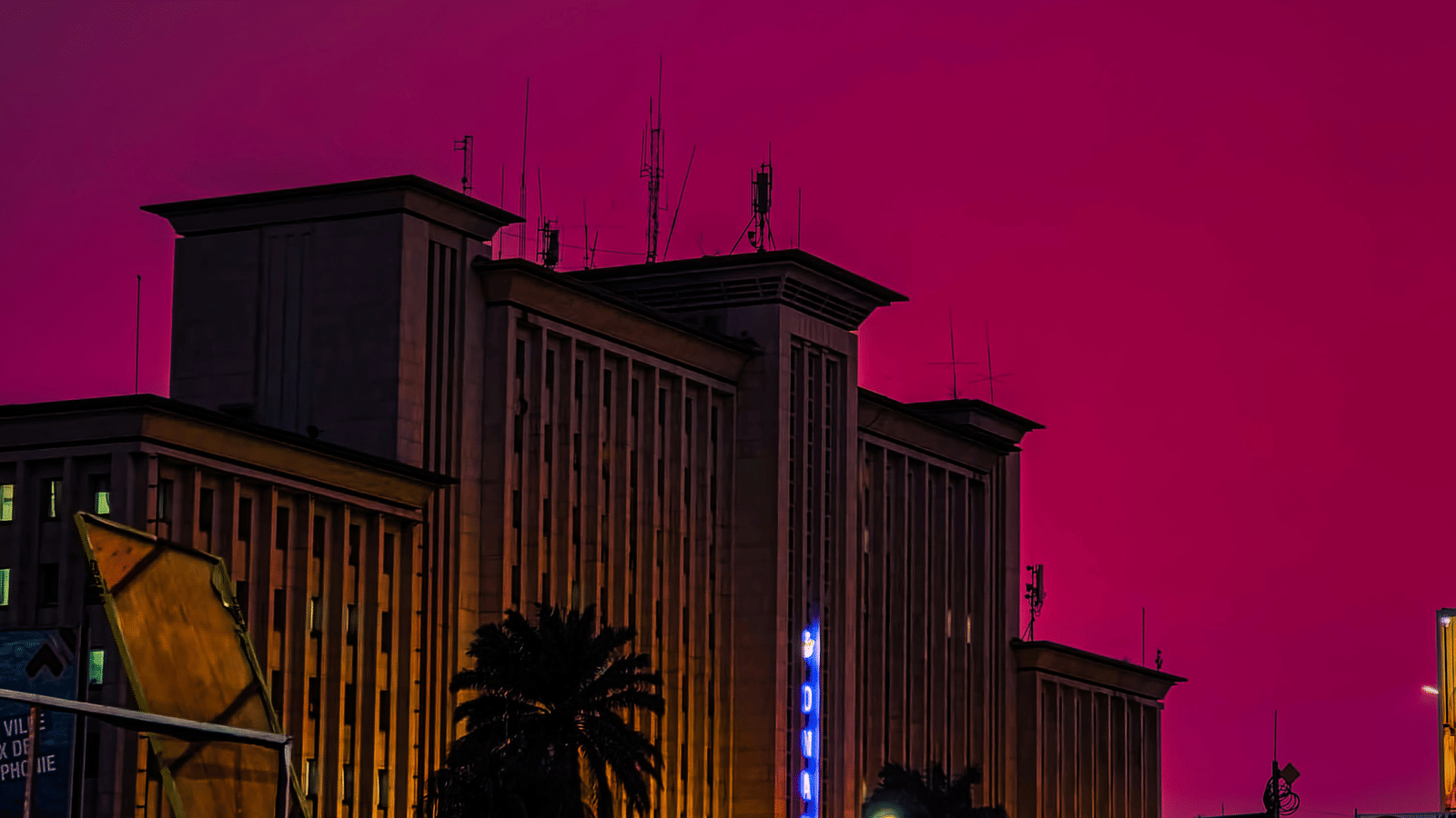 An overview Gare Centrale in Kinshasa during twilight hour with trees in view.