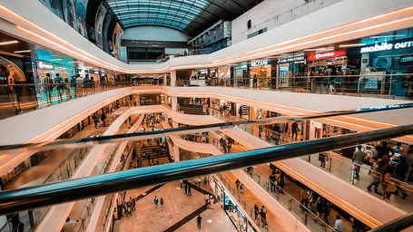 Multi-level Brookefields Mall atrium with glass roofing, escalators, balconies, and retail outlets creating a bright, expansive indoor space