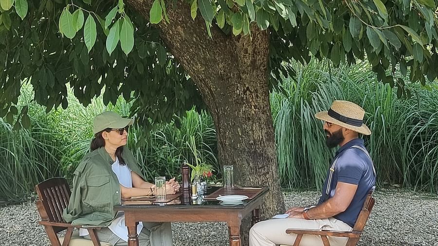 people sitting in the outdoor sitting area surrounded by trees - Aalia Jungle Resort & Spa