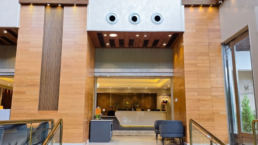 A small staircase with hand rails leading to the reception desk at The Meriton.