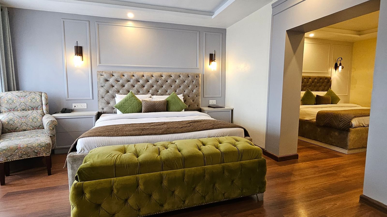 A front view of a bed in a room with wooden flooring | Mongas Hotel & Resort, Dalhousie