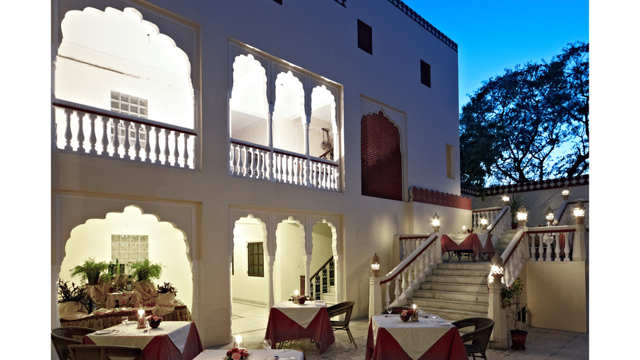Outdoor seating in the courtyard at anada restaurant at Mandawa Haveli, Jaipur