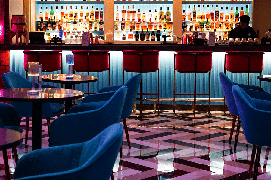 The interiors of the bar features a display of drinks at orchid hotel mumbai vile parle