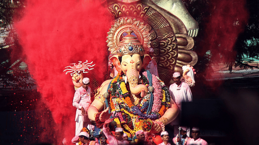 A view from afar of a Ganesh idol with red powdered colour behind it during Ganesh Chaturthi (Mumbai).