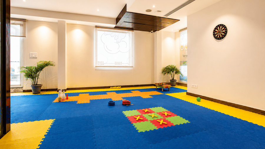 Spacious indoor play area with soft blue and yellow flooring and play mats at Eastlynn Resort, Rishikesh.