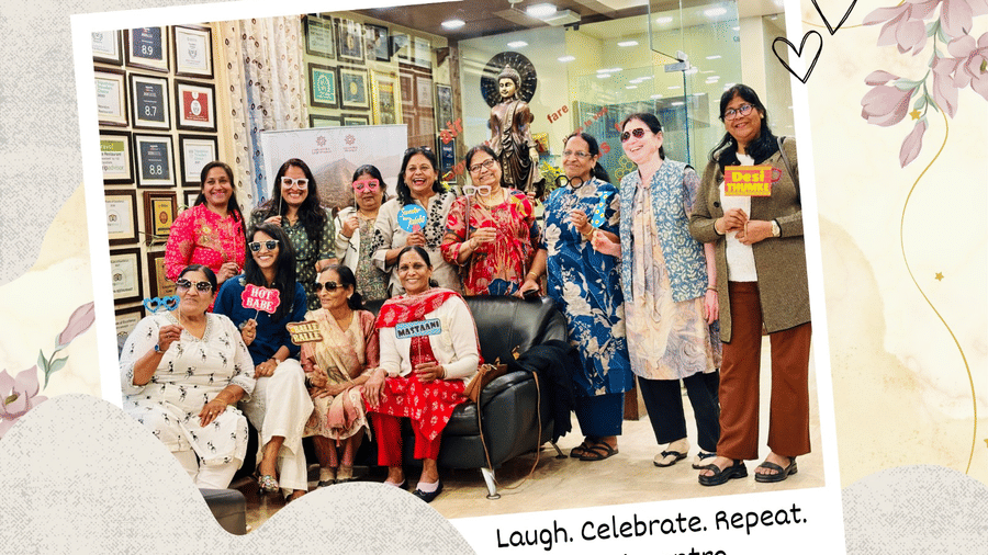 A group of ladies posing for a photograph with elaborate placards - Amantra Comfort Hotel